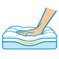 Hand pressing into a cushioned mattress